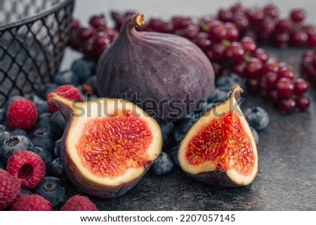 Close-up, figs in the cut among the berries.