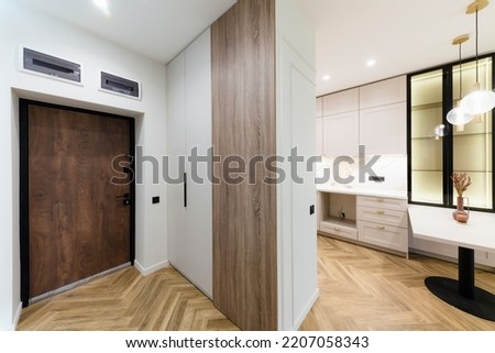 interior design of a new house, a bright corridor with a mirror and a closet