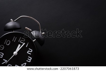 Top view of Black Friday background concept made from  alarm clock on black background. Shopping concept boxing day and Black Friday composition.