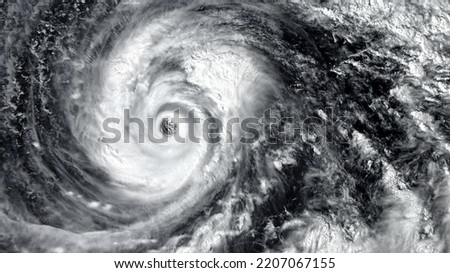 Eye of the Hurricane. Hurricane on a black background. Typhoon over planet Earth. Category 5 super typhoon Views from outer space. Elements of this image furnished by NASA Royalty-Free Stock Photo #2207067155