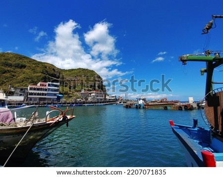 The view of  the harbor with blue sky in Bitou cape New Taipei City in Taiwan. The letters and numbers printed on the boat means theirs name.