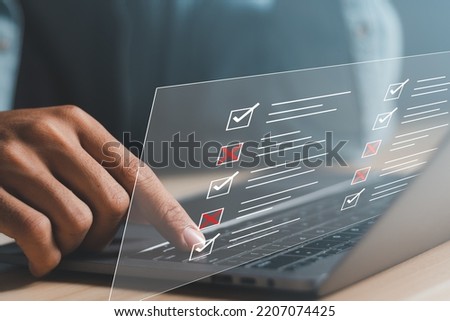 Check marks on checklist and Filling online form or answering questions. Survey form concept.  Education futuristic technology and learning concept. Royalty-Free Stock Photo #2207074425