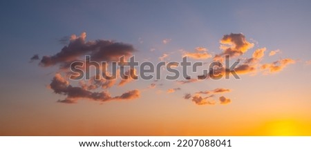 cloudy evening sky with orange sun, summer sunset.
