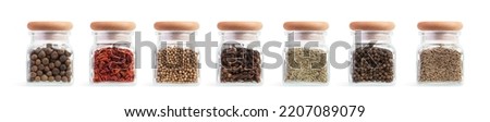 Set of glass jars with different spices on a white isolated background Royalty-Free Stock Photo #2207089079