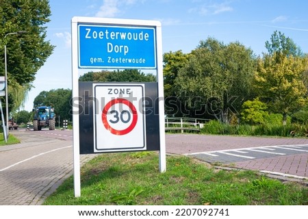 Place name sign of the village of Zoeterwoude-Dorp, municpality of Zoeterwoude. Board below means that in that zone the speed limit is 30.