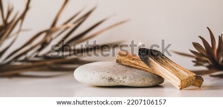Palo Santo sticks on a light background.Aromatherapy religious rituals meditation.Wellness with aromatherapy and the occult.Healing incense Palo Santo.Organic incense of the holy ritual tree.Ibiokai Royalty-Free Stock Photo #2207106157