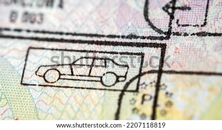 International travel visa passport stamp. Close up macro detail of European Union border control customs admission stamps with car symbol