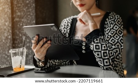 Woman using mobile phone, tablet.Closeup on blurred background
