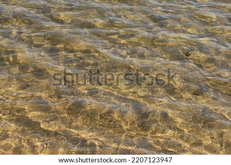 Light wave on the sandy shallow water of a karst lake.