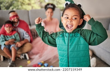 Child, fun and dress up for Halloween with energetic, brave and strong girl playing dress up wearing costume with family at home. Energetic, playful and imagination of kid during pretend game Royalty-Free Stock Photo #2207159349