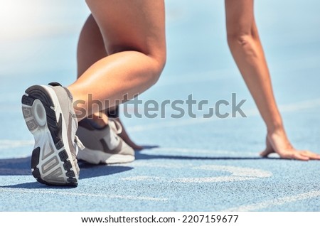 Running, shoes and start with a sports woman or female runner on a track for a workout, exercise or training. Fitness, run and cardio with an athlete getting ready for a competition or race outside Royalty-Free Stock Photo #2207159677