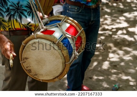 Dominican Republic. The musician plays the drum. Drummer. A group of beach musicians. Merengue music. Royalty-Free Stock Photo #2207167333