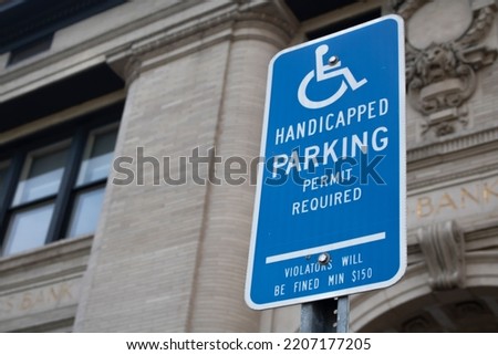 Street sign symbol handicap  Parking Permit Required Violators Will Be Fined Min $150