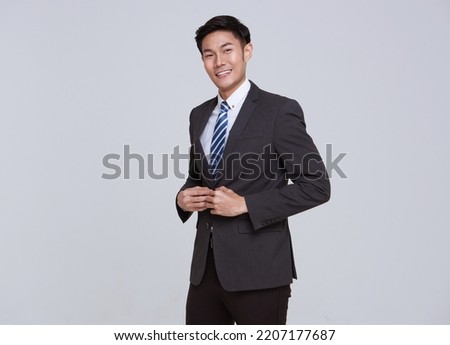 Smiling young handsome southeast Asian businessman in white studio isolated background. Royalty-Free Stock Photo #2207177687