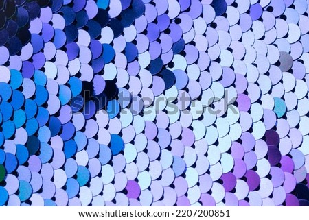 Colorful shiny squama shapes textured background. Graduated shades of blue, green and purple color. Repeating pattern. Flat design.