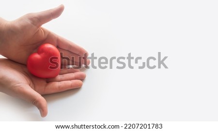 Heart in hands.Organ donation and insurance concept. World heart health concept. World organ donation day. Concept of healthy heart for healthy life. philanthropy idea concept. Royalty-Free Stock Photo #2207201783