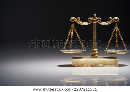 close up of libra scale against gray background                              Royalty-Free Stock Photo #2207211531