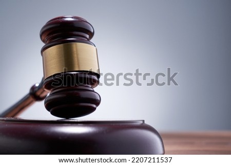 close up of gavel hammer against gray background                    