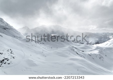 Skiing slope in the French Alpes, fog Royalty-Free Stock Photo #2207213343