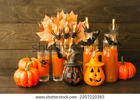 Autumn still life, on a wooden background pumpkin cocktails, yellow maple leaves and decorative pumpkins.  The concept of a festive decorative decoration for Halloween.  Close-up.  Background picture.