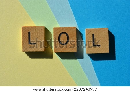 LOL, acronym for Lots of Laughs, letters in wooden alphabet letters isolated on background