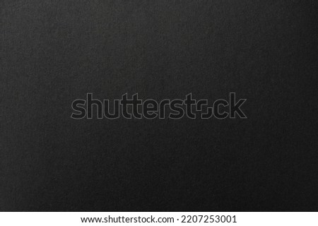 Black paper sharp stack texture background close up view
