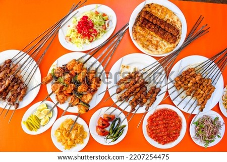 Table scene of assorted take out or delivery foods. Pizza, Pide, hamburgers, Doner, fried chicken and sides. Top down view on a table.