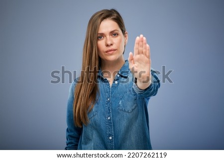 Woman gesturing stop with hand outstretched forward. isolated female portrait.