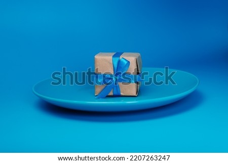 A gift on a blue plate. A gift on blue background