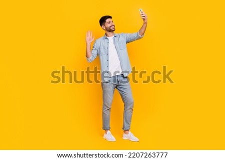 Full length photo of cheery handsome latin man take selfie video call blogger dressed trendy denim look isolated on yellow color background Royalty-Free Stock Photo #2207263777