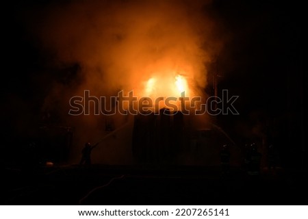 Firemen put out a fire on a transformer after the missile attack in Ukraine Royalty-Free Stock Photo #2207265141
