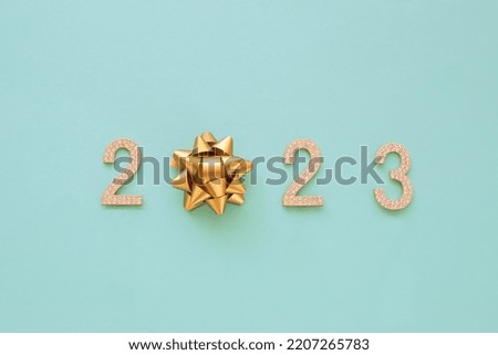 Happy New Year 2023. Golden numbers with rhinestone text 2023 isolated blu background. Beautiful bright design element for greeting card and holiday flyer. Royalty-Free Stock Photo #2207265783