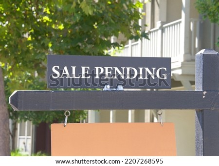 Close up on Sale Pending sign in front of a California Home. Housing crisis, homes for sale.

