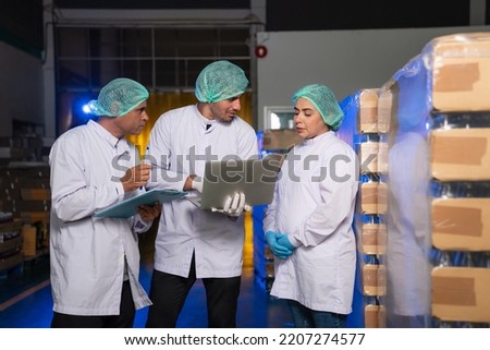 Team of worker quality control using laptop Inspecting glass bottle packaging for fruit juice drinks, Worker QC working in a drink water factory