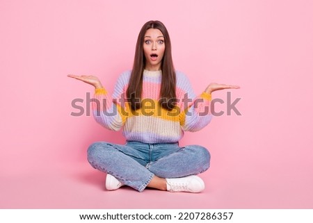 Full length portrait of impressed speechless person arms hols demonstrate empty space scales isolated on pink color background
