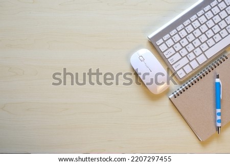 Mockup of a workspace desk in a flat lay top view. Image of a workspace with a laptop, calculator, keyboard and notebook on background, desk concept