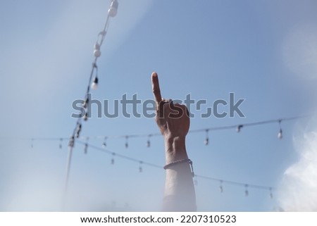 index finger on blue sky background
