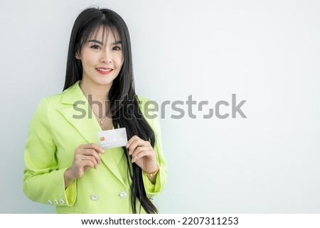 Beautiful Asian woman holding credit card on white background, Asian woman smiling showing presenting credit card, Woman holding bank business credit card, copy space.