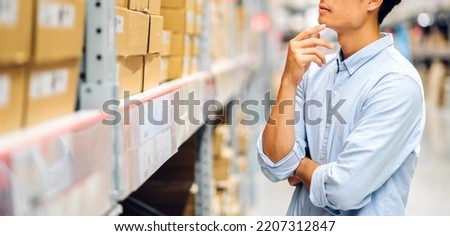 Portrait of smiling asian engineer foreman in helmets man order details checking goods and supplies on shelves with goods background in warehouse.logistic and business export