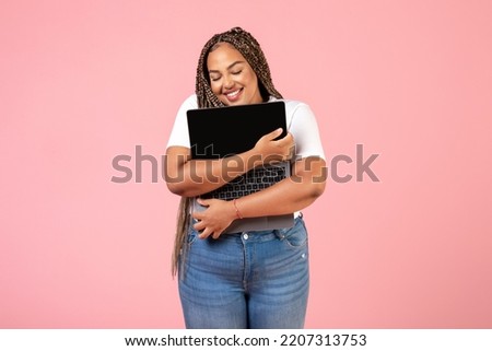 Happy Black Freelancer Woman Hugging Laptop Computer Advertising Website Standing Over Pink Studio Background. Freelance Career And Internet Technology Concept