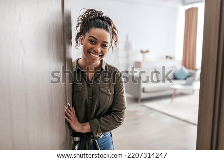 Real Estate Offer. Happy Black Lady Opening Door Smiling To Camera Meeting You At Home. Welcome To My New House, Smiling To Camera. Apartment Ownership And Purchase Concept Royalty-Free Stock Photo #2207314247
