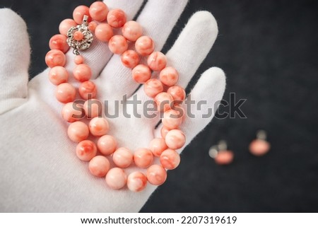 Beautiful vintage red coral necklace on black background Royalty-Free Stock Photo #2207319619