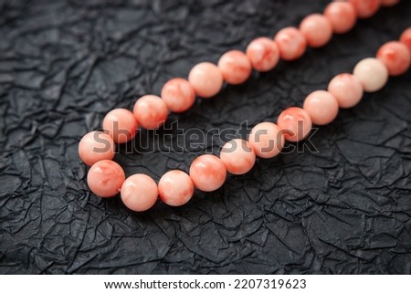Beautiful vintage red coral necklace on black background Royalty-Free Stock Photo #2207319623