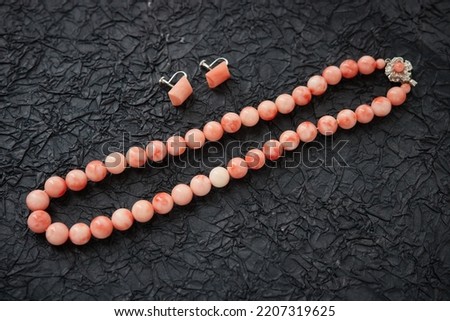 Beautiful vintage red coral necklace on black background Royalty-Free Stock Photo #2207319625