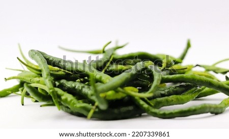 green curly chili isolated on a white background