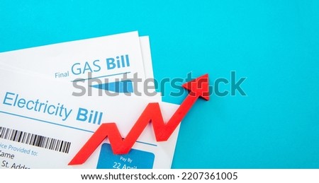Utilities accounts and red rising up arrow. Electricity and gas bills. Heating and energy cost increase concept. 

 Royalty-Free Stock Photo #2207361005
