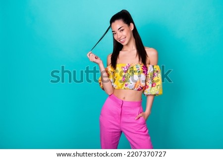 Portrait photo of young smiling attractive girl showing new shampoo hair isolated on aquamarine color background