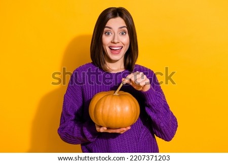 Portrait of charming positive person hand hold pumpkin have good mood isolated on yellow color background