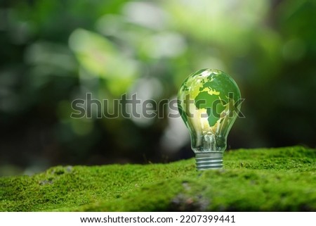 Renewable Energy.Environmental protection, renewable, sustainable energy sources. Green world map on the light bulb on green background .green energy. Renewable energy is important to the world Royalty-Free Stock Photo #2207399441
