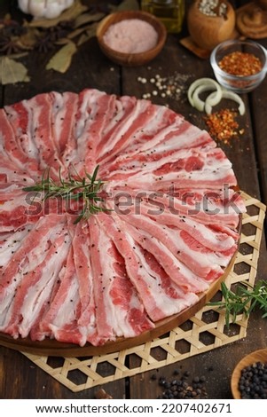 Raw Beef Sliced for Barbeque with Rosemary, Pepper and Spices. Messy Food Photography